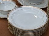 a lot of plates and bowls on the table