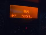 the dashboard of a car with a digital clock on it ' s display