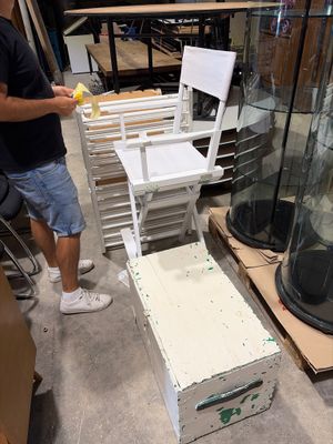 a man that is standing in a room with a chair