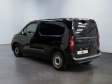 a picture of a black van parked in a room