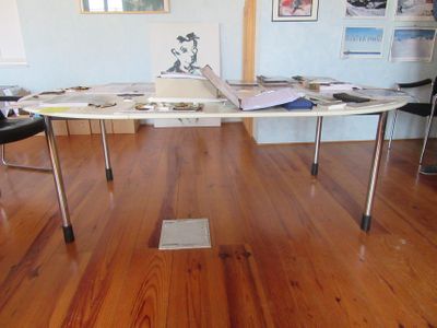 a surfboard on a table in the middle of a room