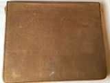 a close up of a wallet on a table with a white background