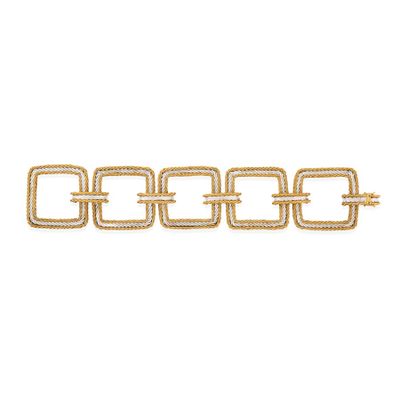 a close up of a gold chain bracelet on a white background