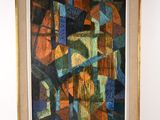 painting of abstract shapes in a gold frame on a white wall