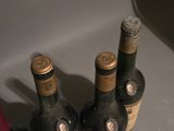 three bottles of wine sitting next to each other on a counter