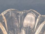 a clear glass bowl with a spoon inside of it