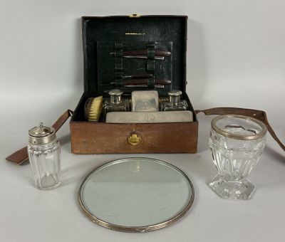 a suitcase with a mirror and a glass on the table