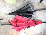 two umbrellas sitting on the ground next to each other