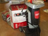 a box of tools on the floor next to a vacuum