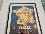 a framed picture of a map of france on the wall