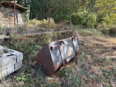 an old stove and an old stove sitting in the grass