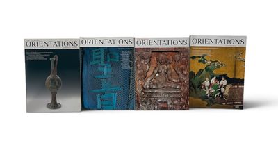 three books of oriental oriental art on display on a white surface