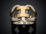 a close up of a silver and gold ring on a black surface