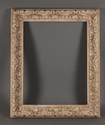a large carved wood frame with a scroll design