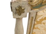 a close up of a chair that has a gold and white pattern on it