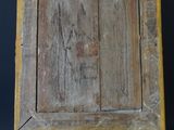 an old wooden easel with a painting on it against a black background
