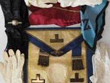 an assortment of gloves, gloves, and a purse on a table