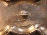 a close up of a metal object with a face on it
