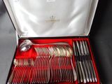 silverware in a red box on a table with a black table cloth