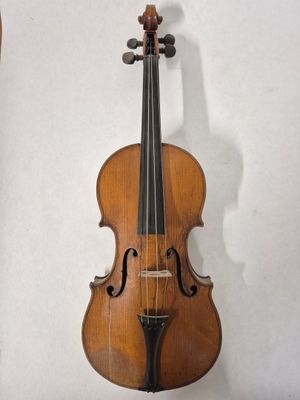 an old violin hanging on a wall in a room