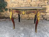 an image of a small table with a red and gold decoration on it