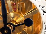 a close up of a clock with writing on it