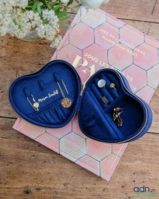 a pair of blue heart shaped jewelry boxes sitting on top of a wooden table