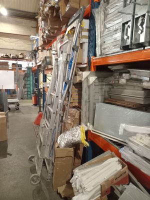 a ladder that is leaning against a wall in a warehouse