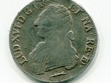 une vieille pièce de monnaie sur laquelle figure le profil d'une femme, sur un fond blanc