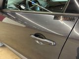 a close up of a car door handle with a sticker on it