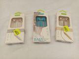 three boxes of ear buds are sitting next to each other