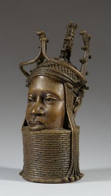a bronze head of a woman with a crown on her head