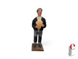 a figurine of a man holding a teddy bear