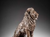 a bronze statue of a lion on a pedestal