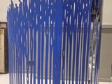 a blue sculpture made of people standing in a circle