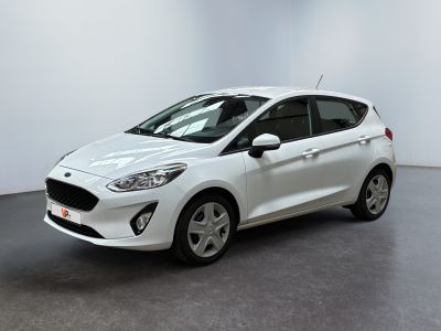 a white ford fiesta parked in a white room