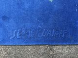 a blue door mat with a green heart on it