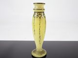 a yellow vase that is sitting on a black table