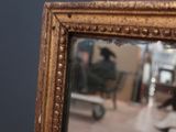 a reflection of a man in a mirror in a room