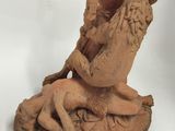 a statue of a man riding a horse with a dog