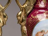 pair of vases decorated with a painting of a woman and a man