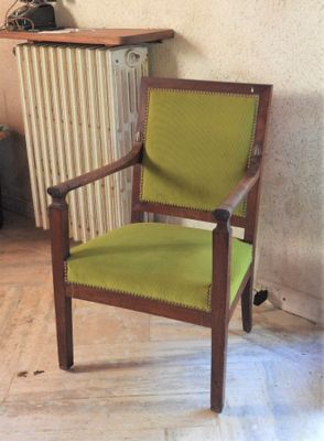 a green chair that is sitting in front of a radiator