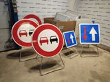 three signs that are sitting on a stand in a room