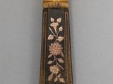 a black and gold vase with flowers on it