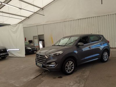 a grey suv parked in a garage with other cars