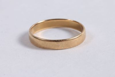 a close up of a gold ring on a white surface