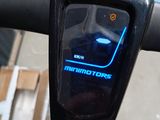 a close up of a bike handlebar with a clock on it