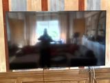 a flat screen tv sitting on a stand in a living room
