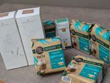 several packages of coffee sitting on a table next to a box of coffee