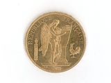 a gold coin on a white surface with a bird on it